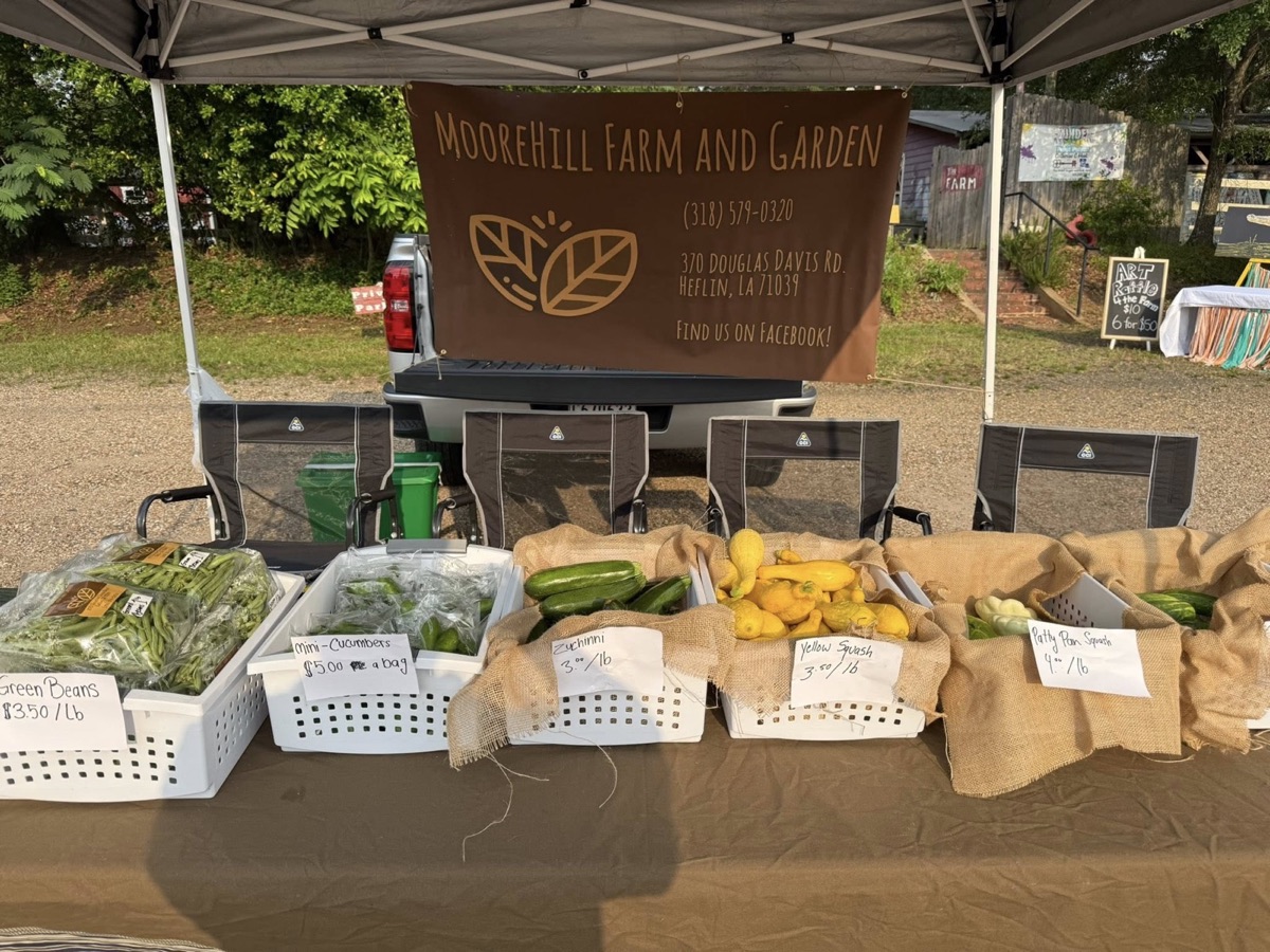 Moore Hill Farm and Garden produce displayed at a farmers market stand